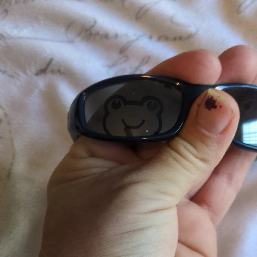 Black And Blue Baby Sunglasses With A Sleek Design Of A Frog On One Of The Lense